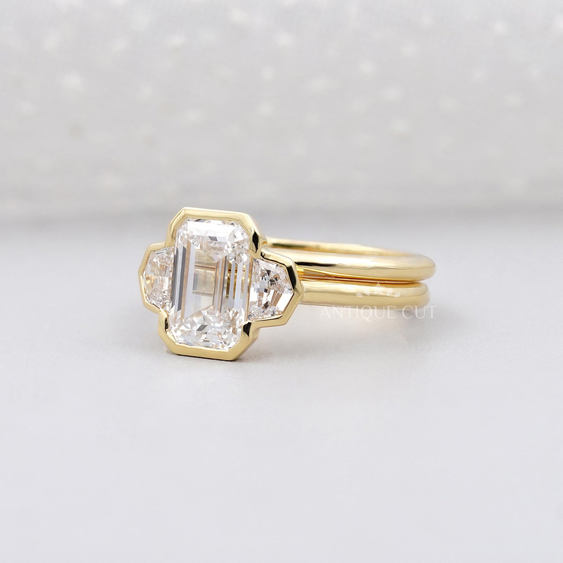 Gold ring with a diamond on a light gray background


