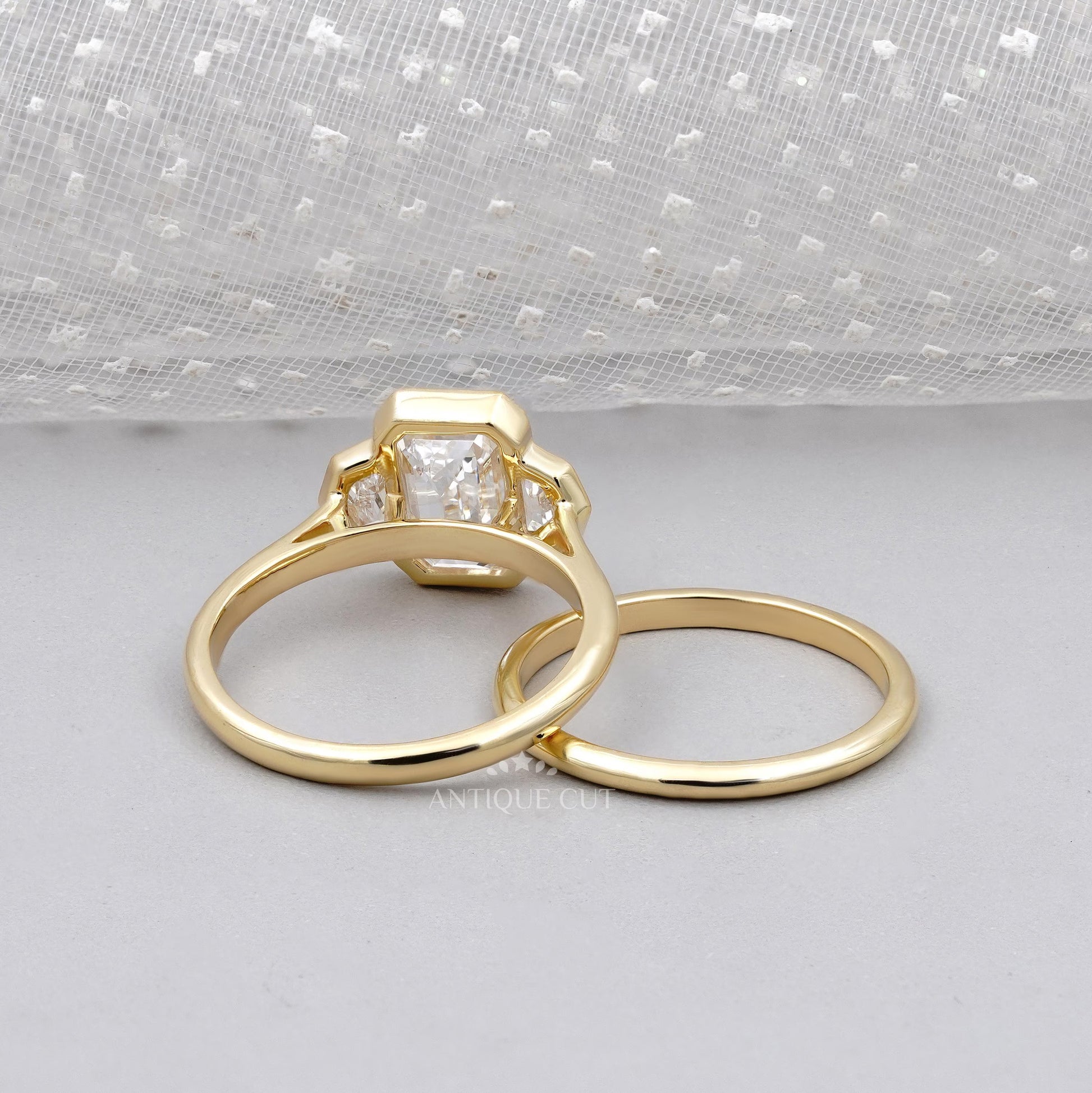 Gold ring with a diamond on a gray surface

