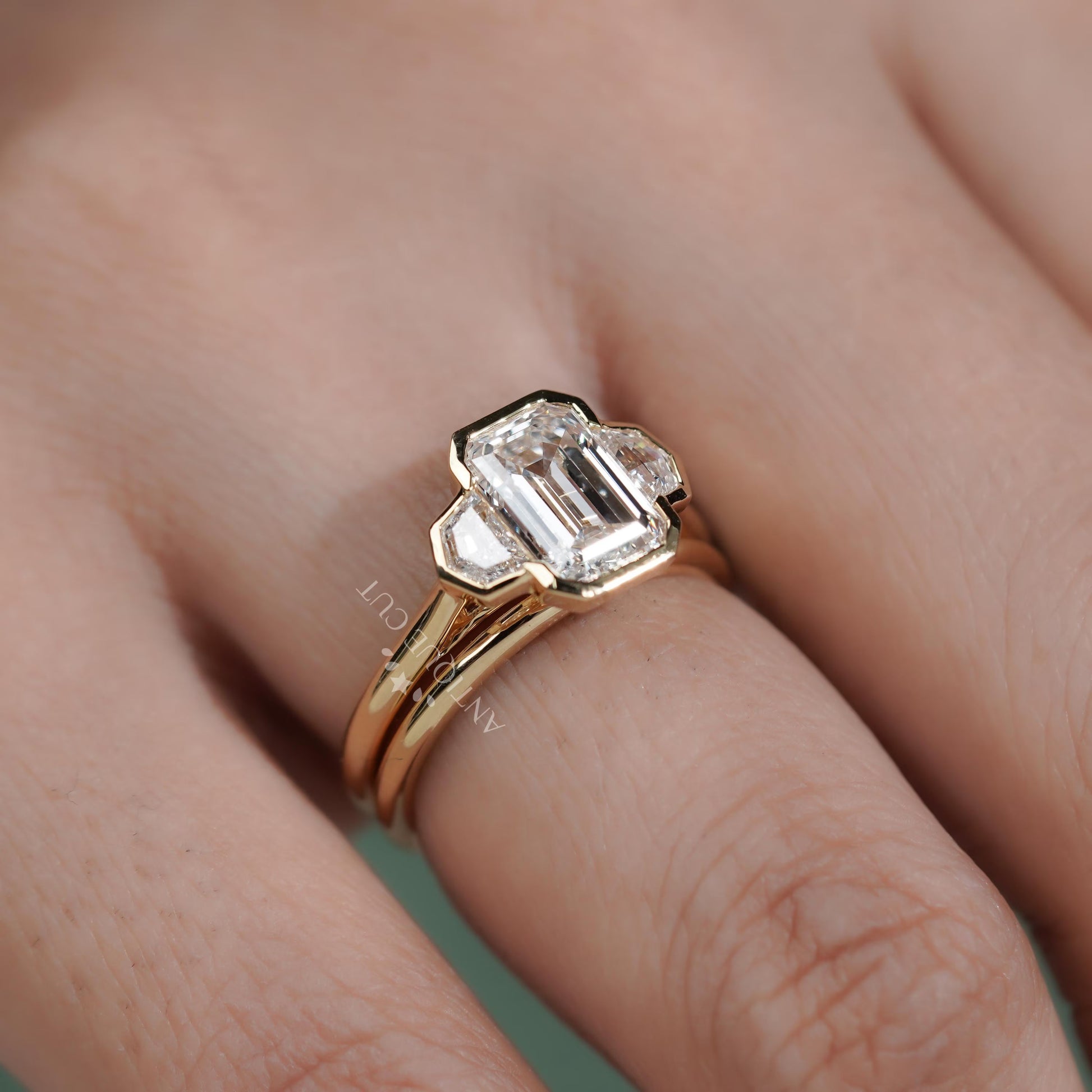Gold ring with a diamond on a finger 
