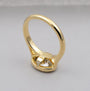 Gold ring with a diamond on a gray background