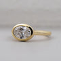 Gold ring with a large diamond on a gray background

