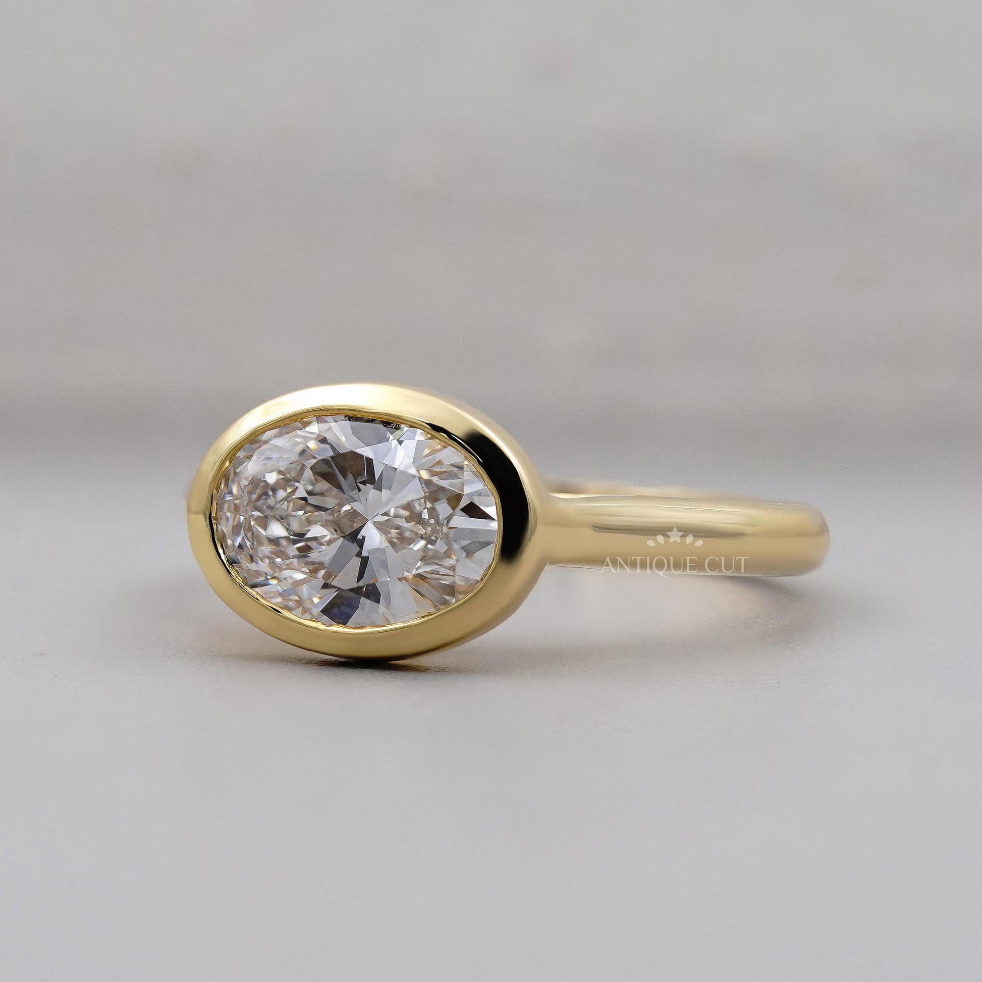 Gold ring with a large diamond on a gray background

