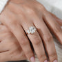 Close-up of a hand wearing a diamond ring with a soft background


