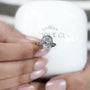 Diamond ring held by a hand with a white box labeled 'Antique Cut' in the background

