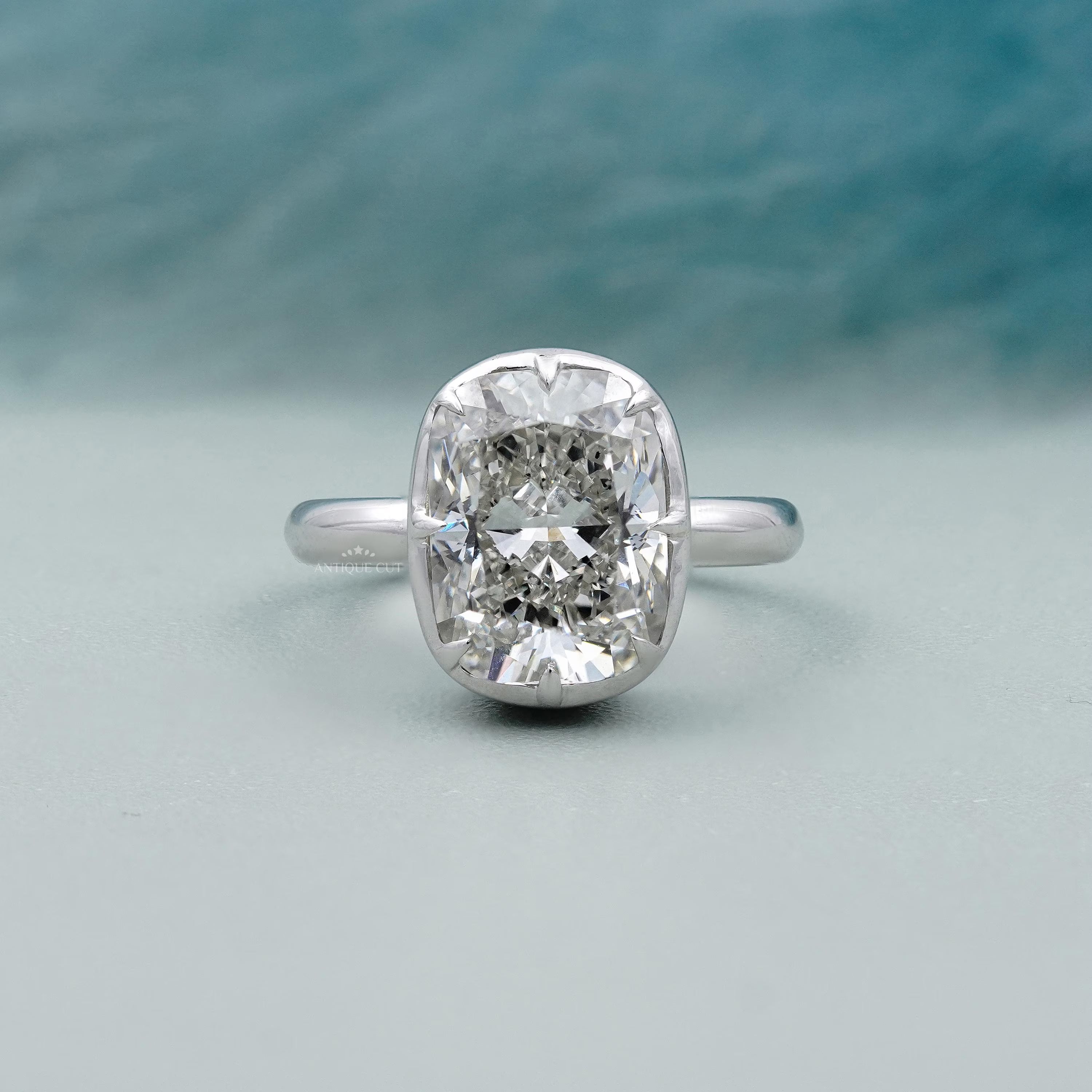 Diamond ring with a silver band on a light blue background

