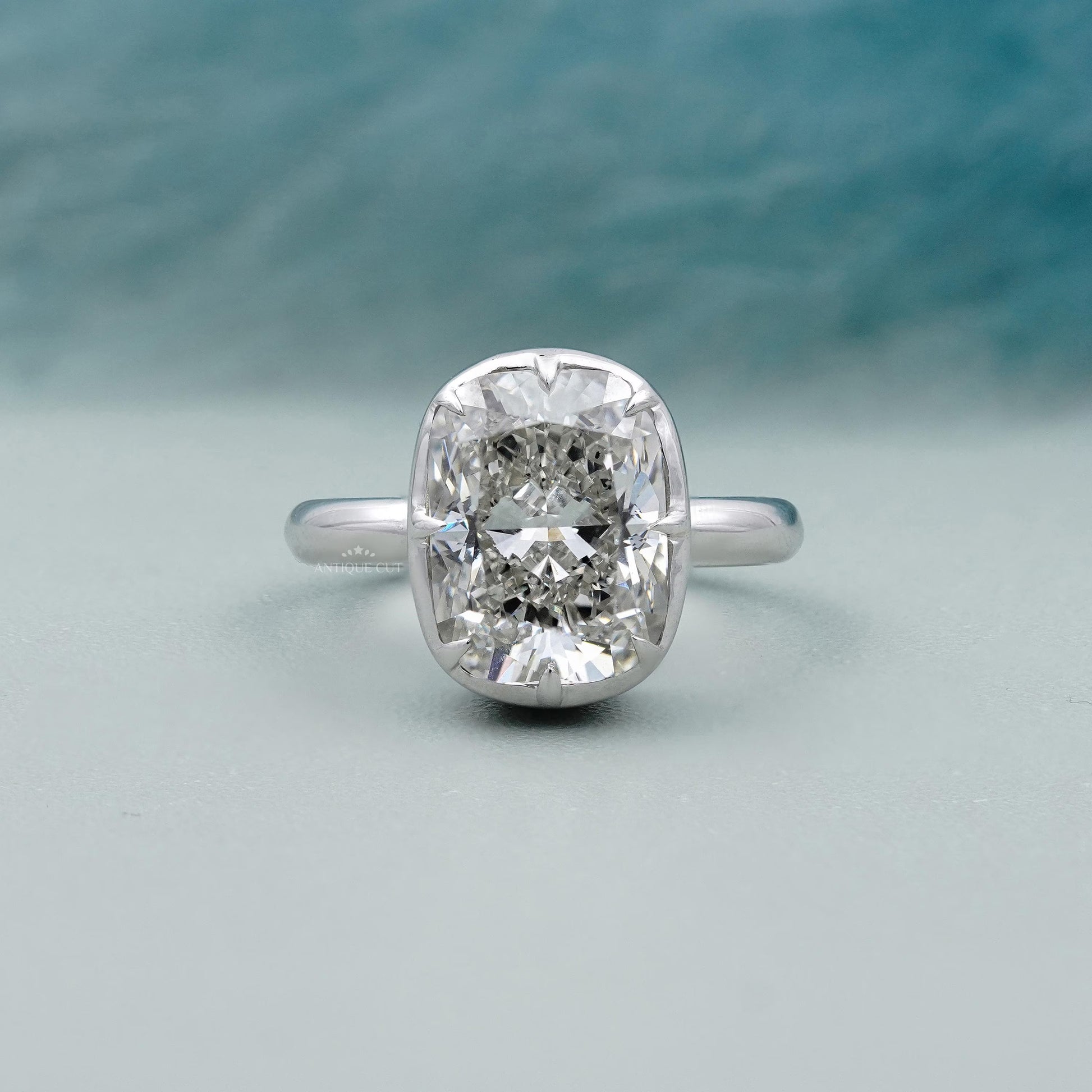 Diamond ring with a silver band on a light blue background

