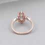 Rose gold ring with a diamond on a light gray background

