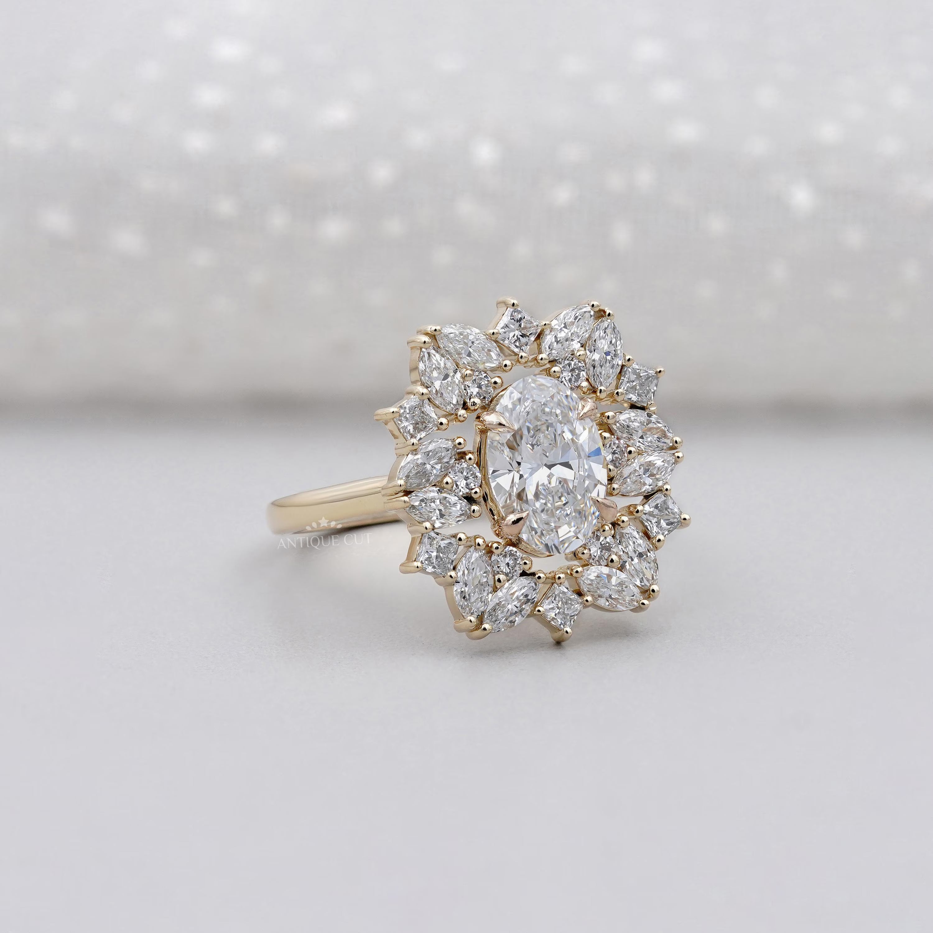 Diamond ring with a cluster of diamonds on a light background

