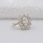 Diamond ring with a cluster of diamonds on a light background

