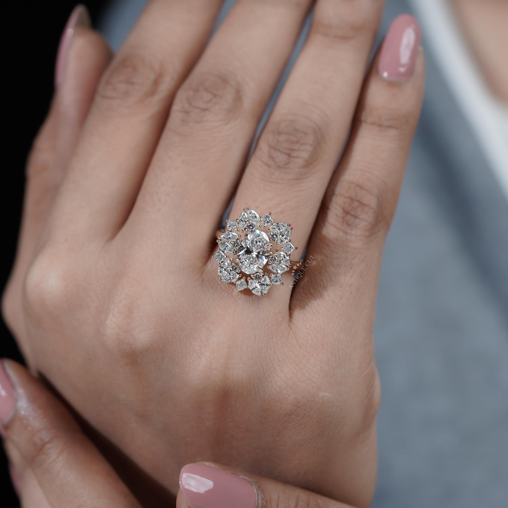 Close-up of a hand wearing a diamond ring with a blurred background