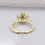 Gold ring with a diamond on a light gray background

