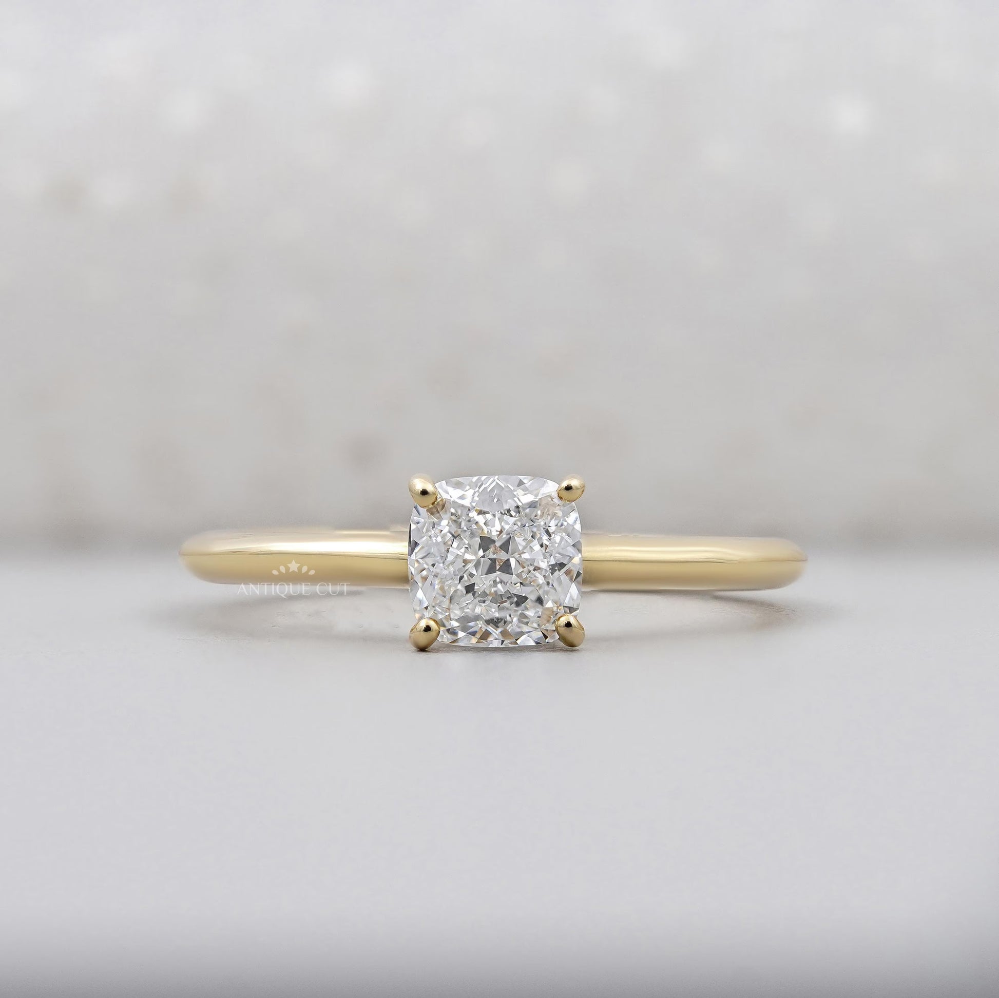 Cushion cut diamond ring in yellow gold with hidden accent