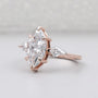 Rose gold ring with a large marquise-shaped diamond on a light gray background

