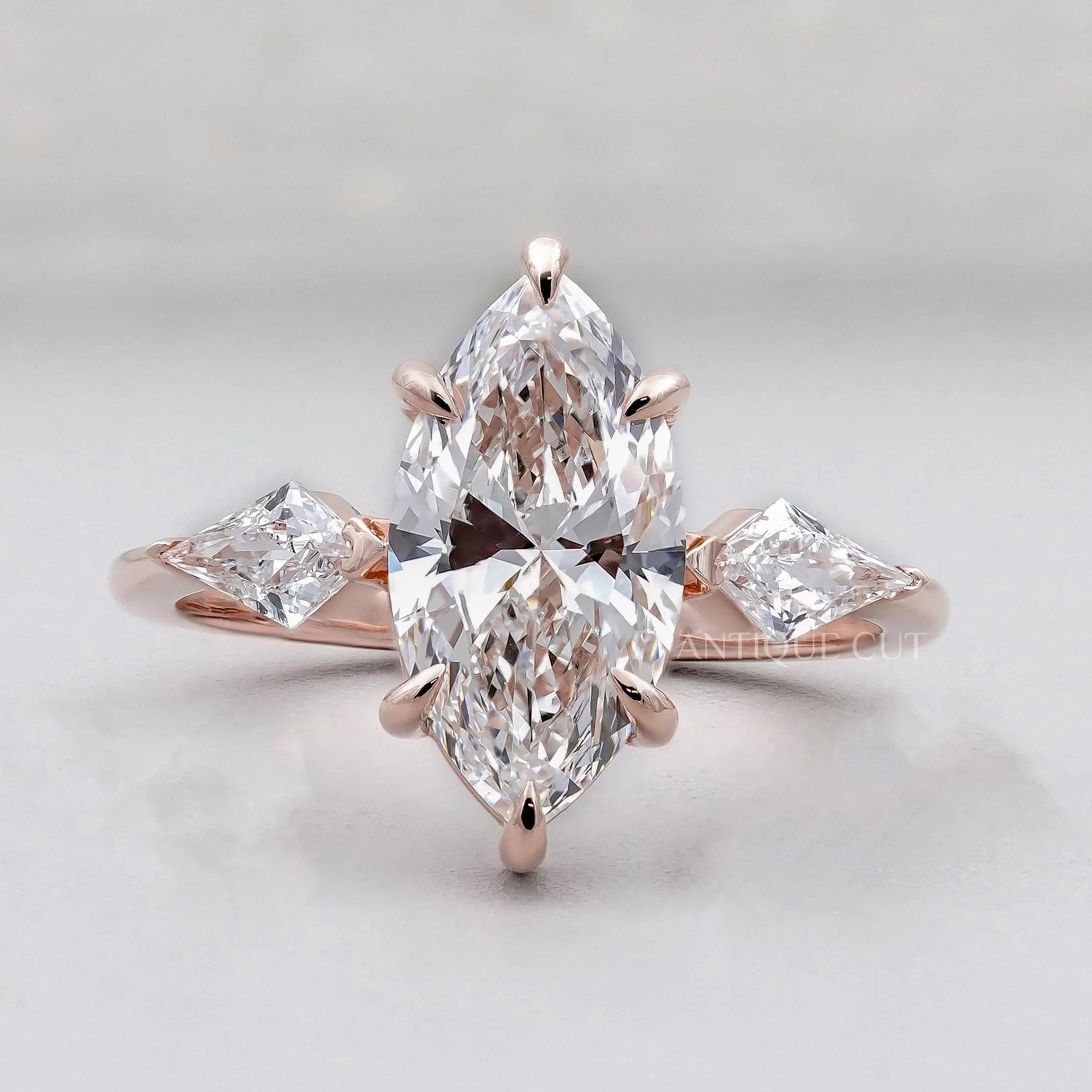 Three stone marquise engagement ring in rose gold
