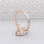 Rose gold ring with a clear gemstone on a white background

