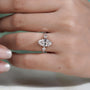 Diamond ring on a finger with a blurred background

