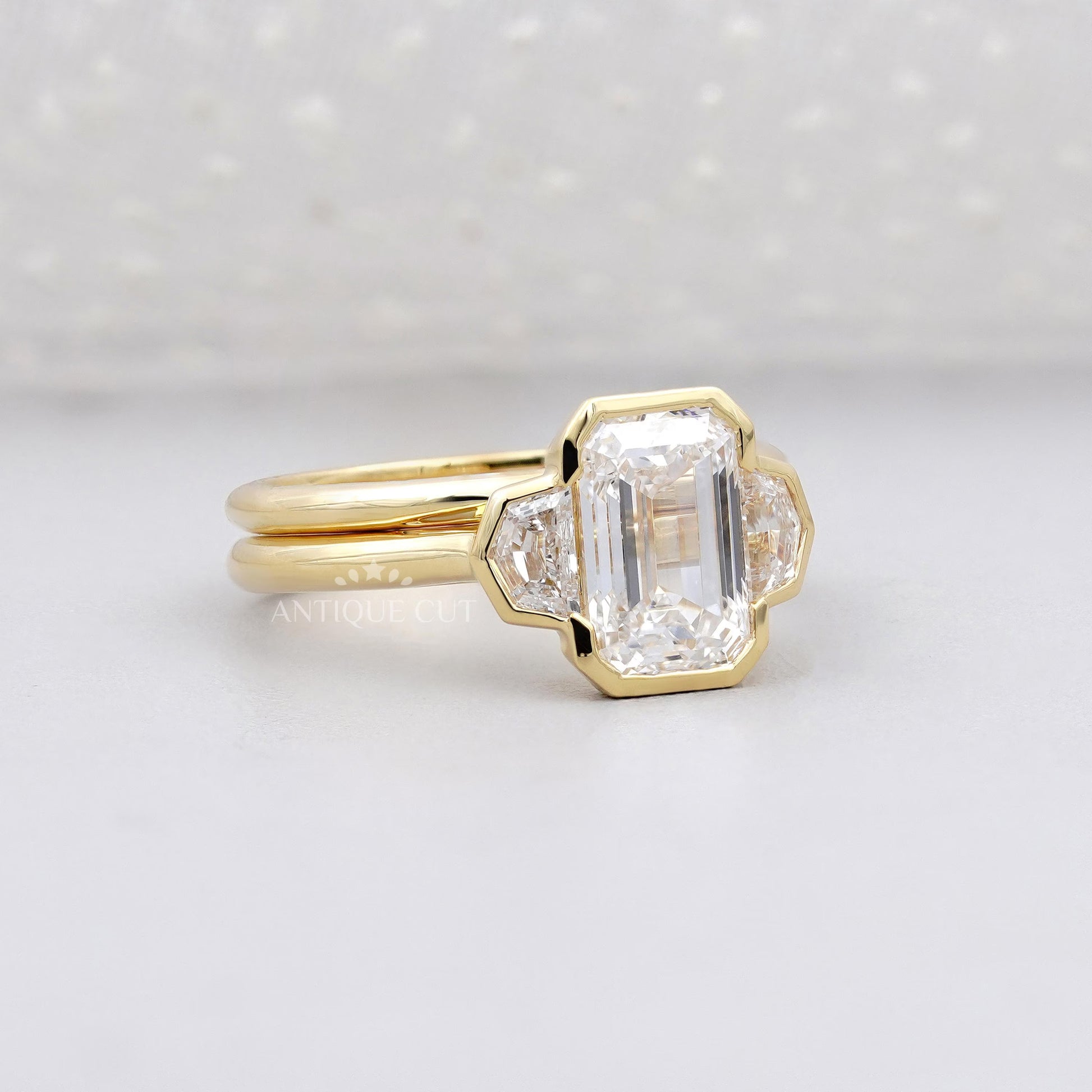 Gold ring with a large diamond on a light gray background

