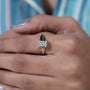 Close-up of a hand wearing a diamond ring 
