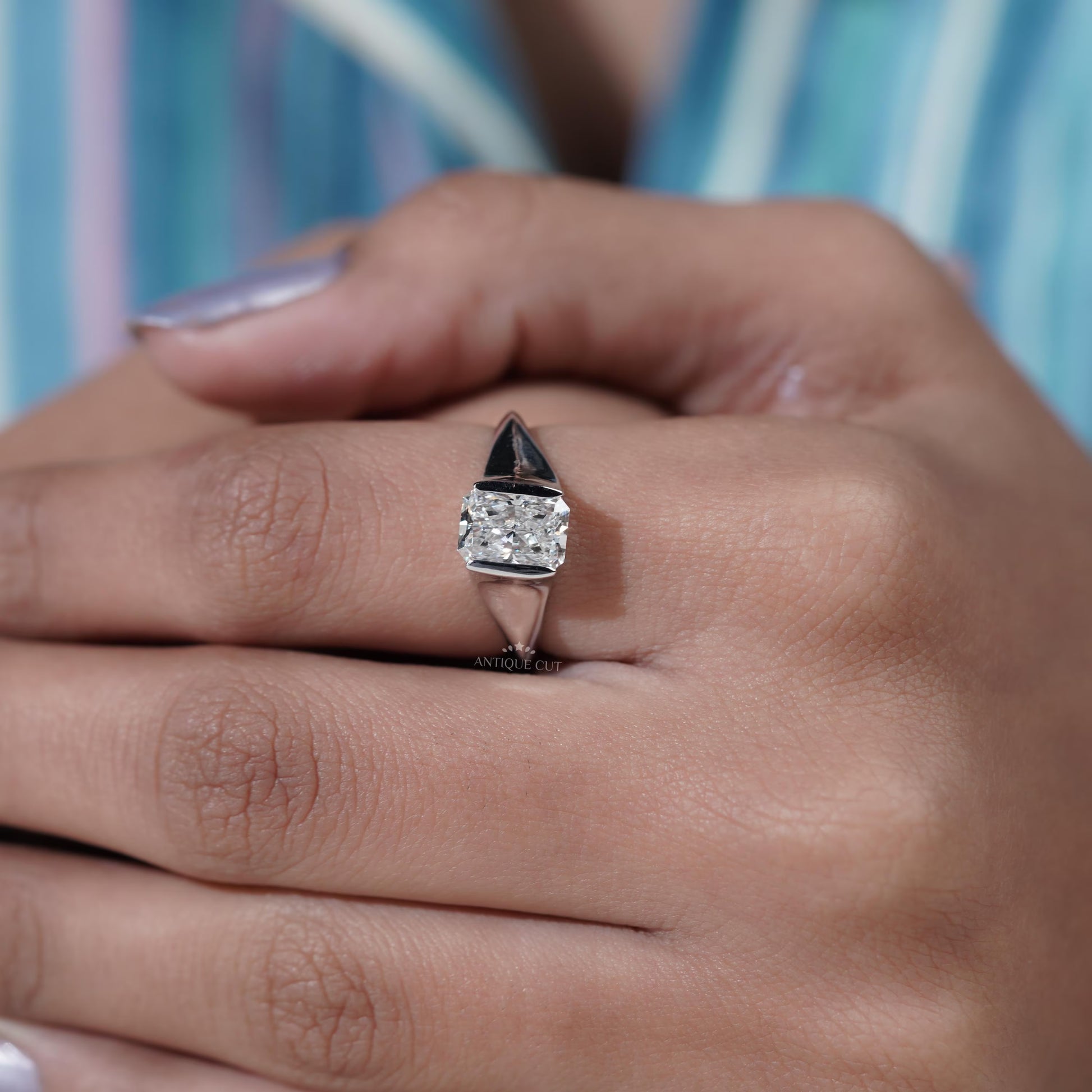 Close-up of a hand wearing a diamond ring 