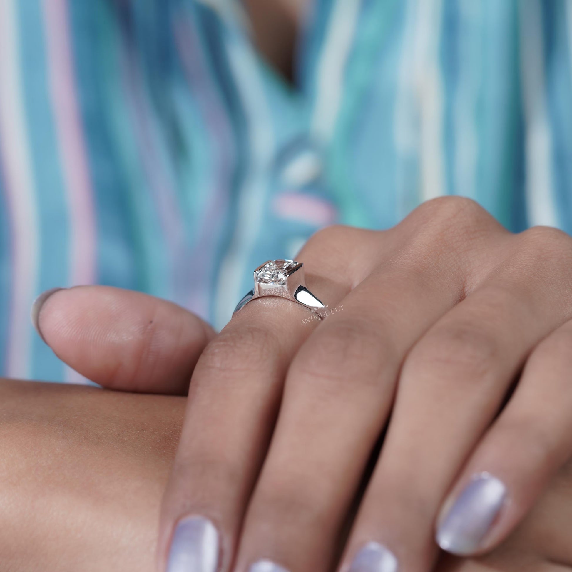 Close-up of a hand wearing a diamond ring 