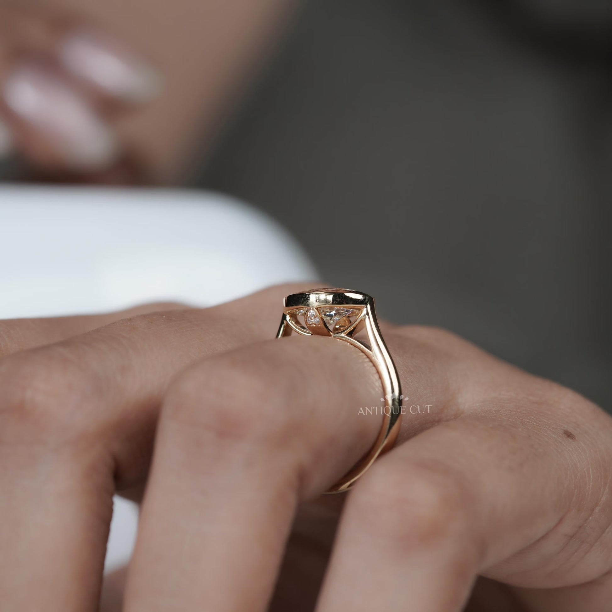 Rose gold ring with a diamond on a person's finger