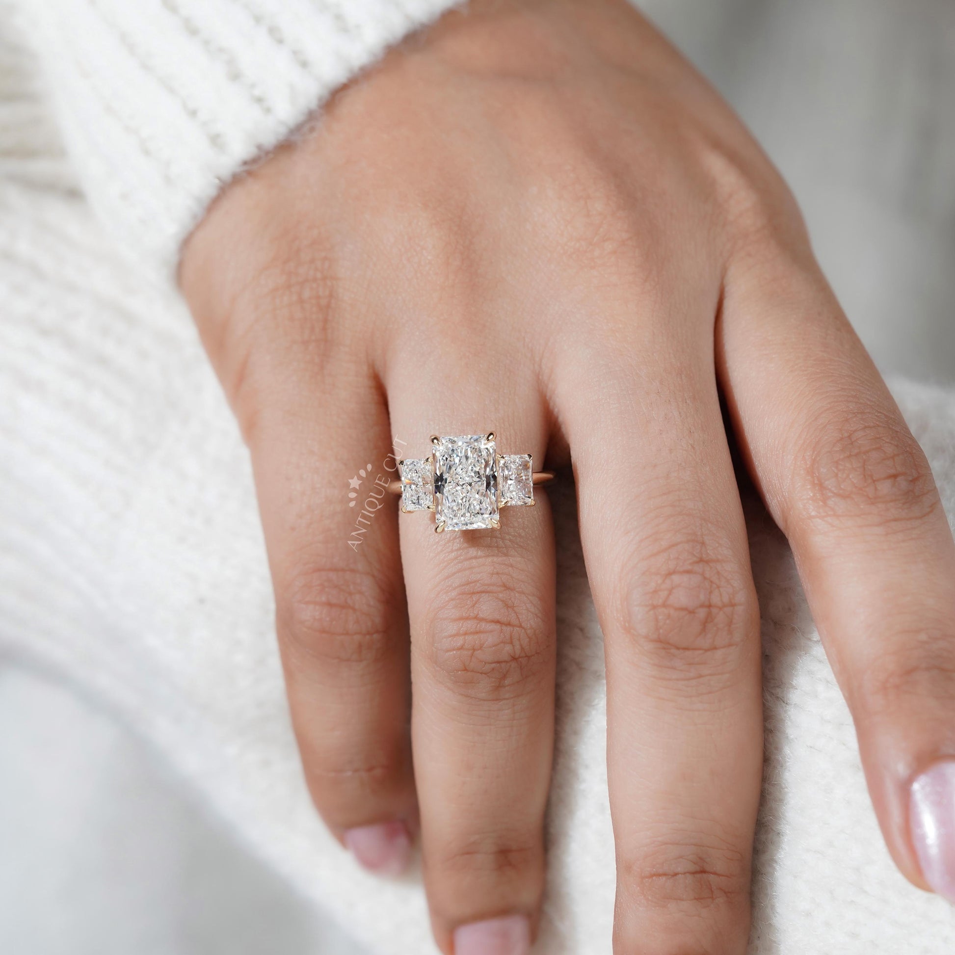 Hand wearing a diamond ring on a white background

