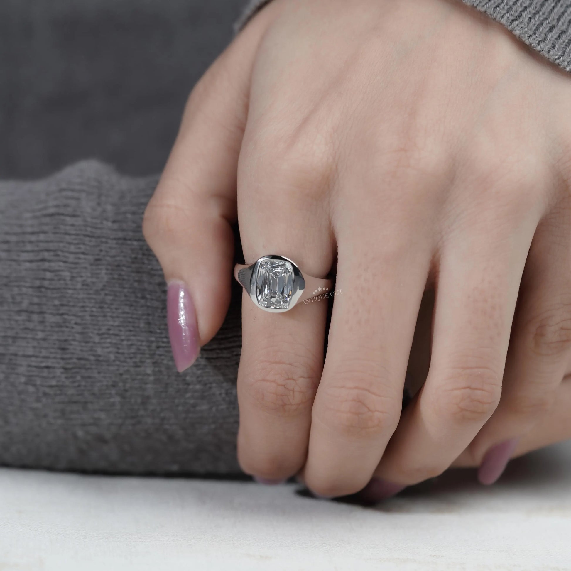 Silver ring with a diamond on a finger
