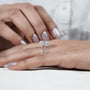 Diamond ring held by a hand with 'AntiqueCut' branding in the background
