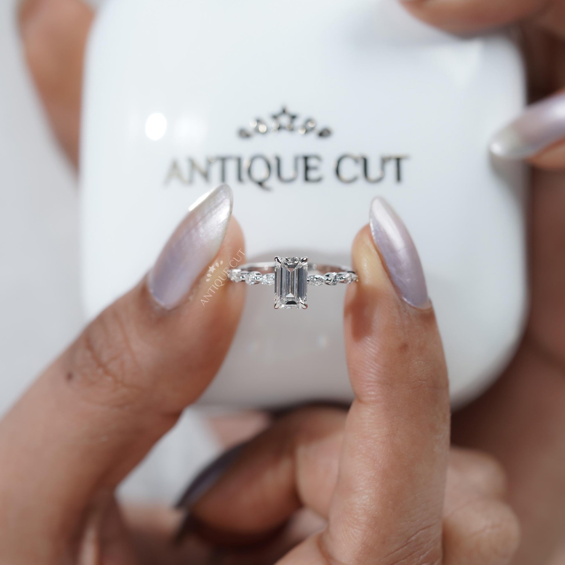 Elegant white gold emerald cut engagement ring