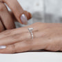 Silver ring with a diamond on a hand with light purple nail polish

