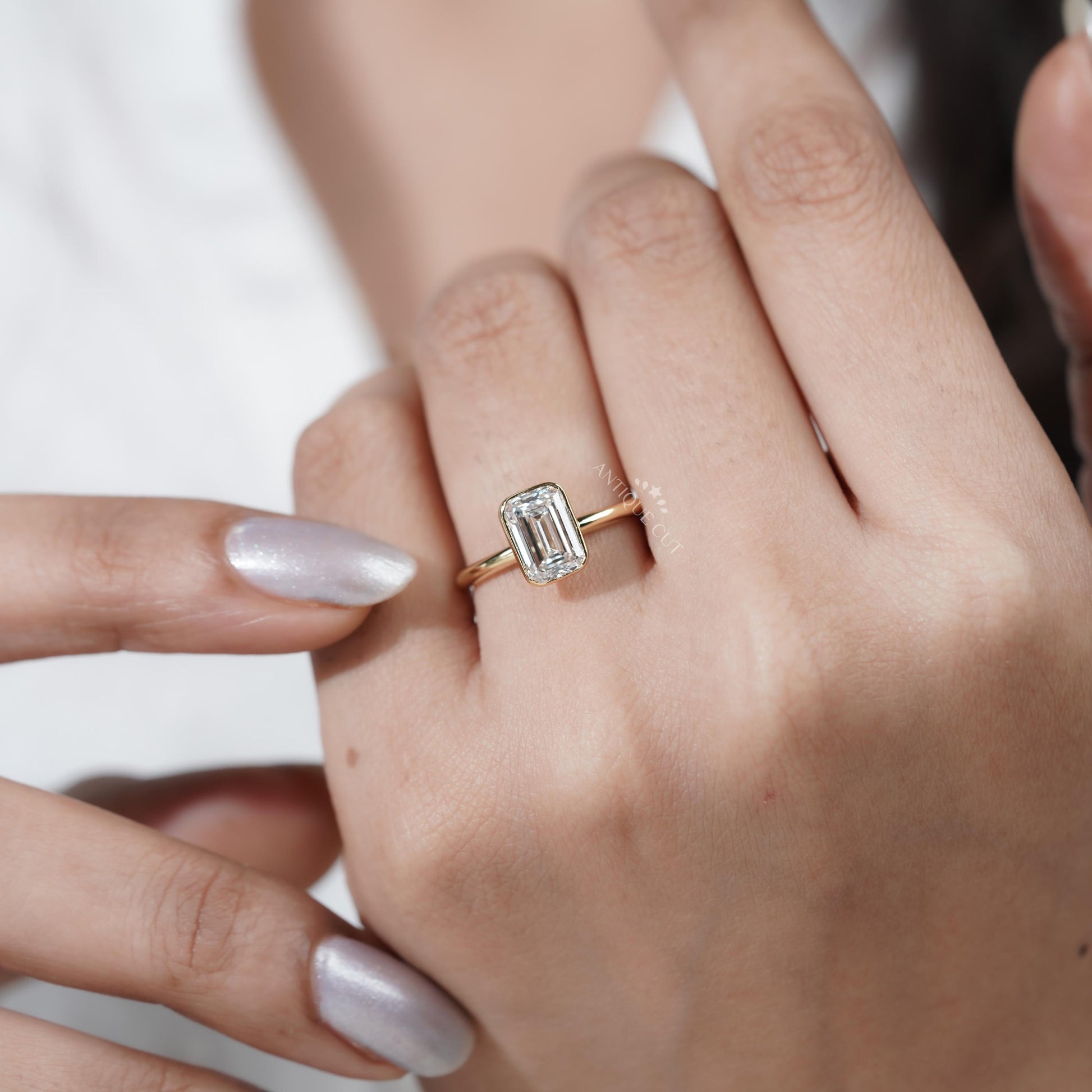 Bezel setting emerald diamond engagement ring