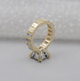 Gold ring with diamond accents on a gray background

