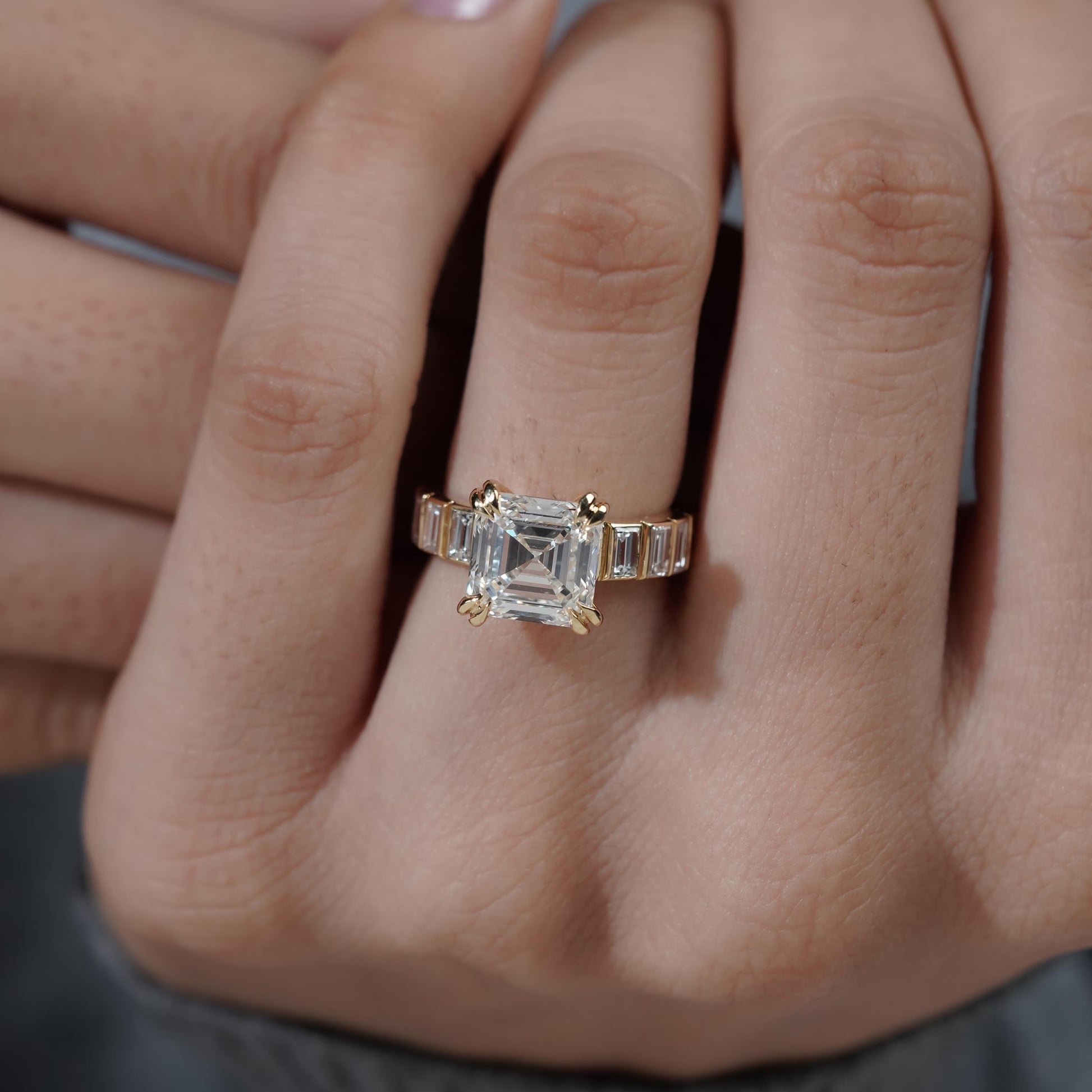 Gold ring with a diamond on a person's finger

