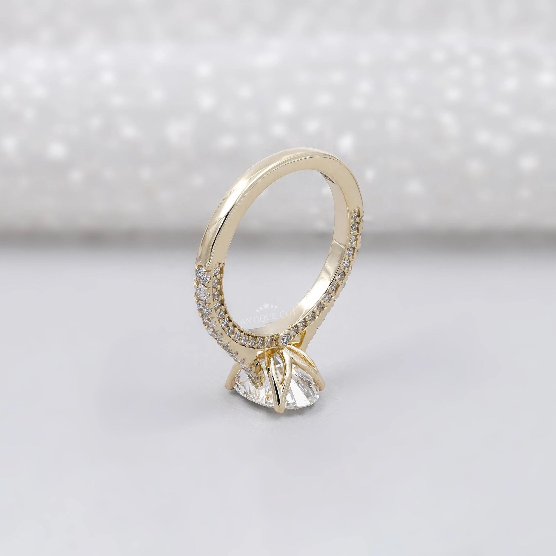 Gold ring with a diamond on a light gray background

