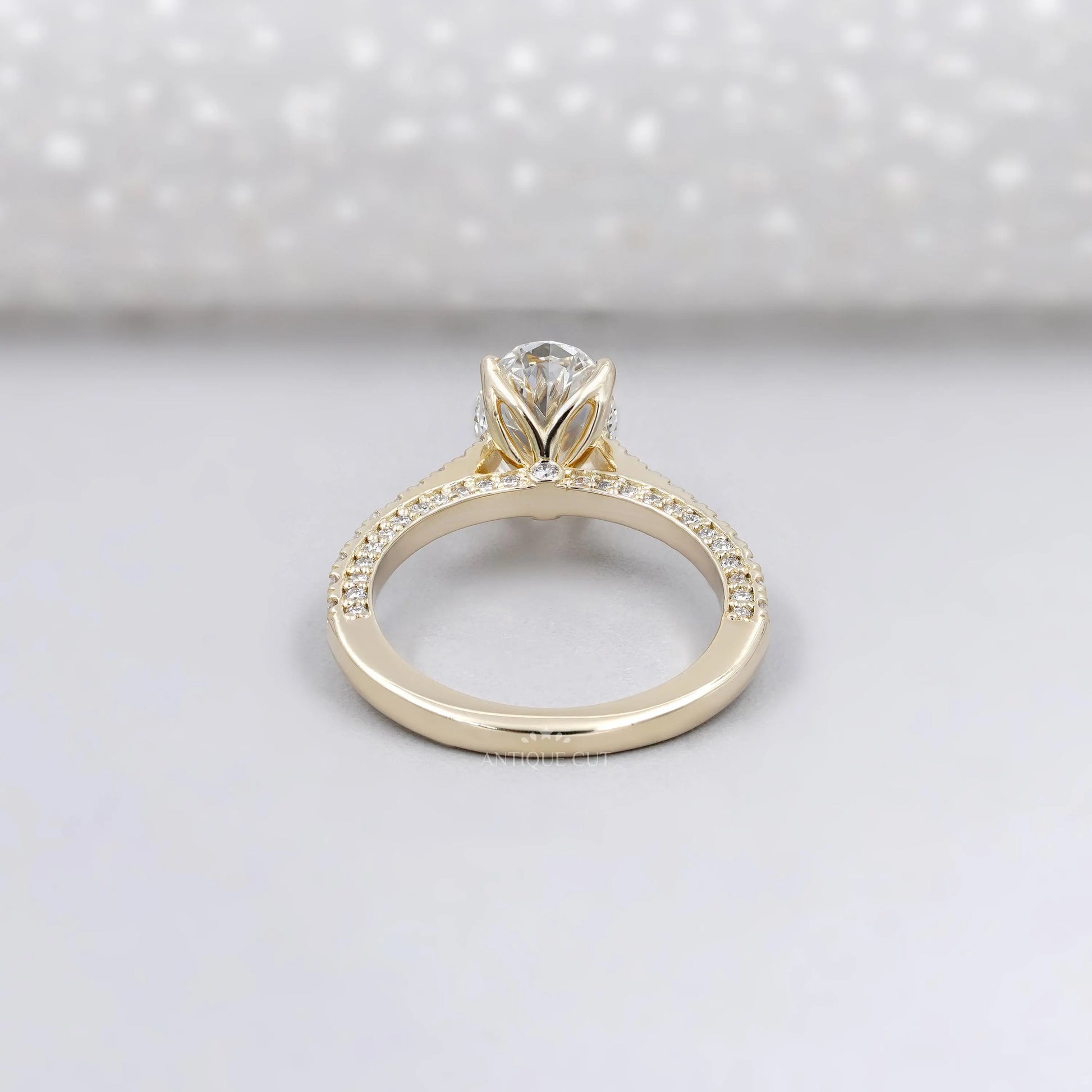 Gold ring with a diamond on a light gray background


