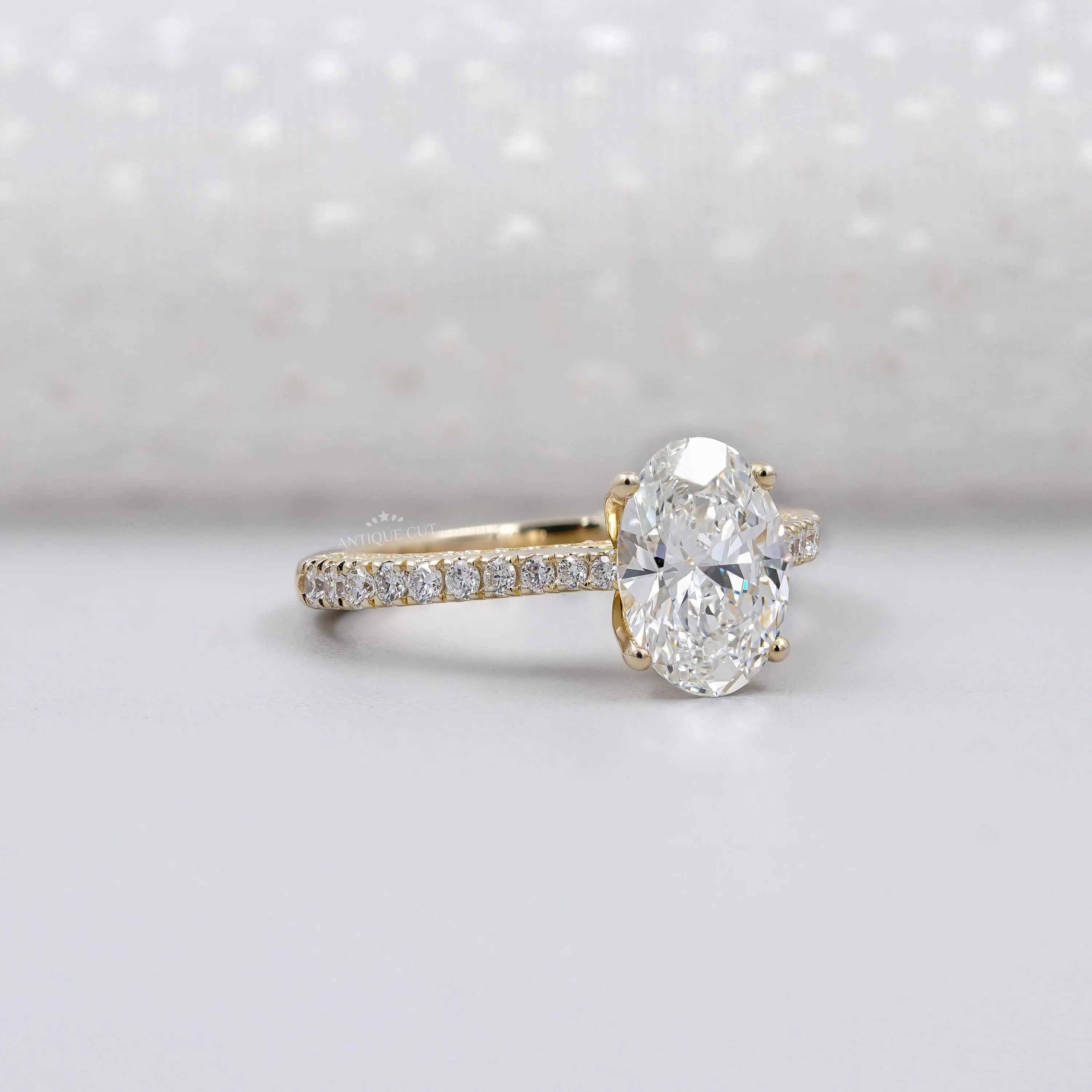 Diamond ring with gold band on a light gray background

