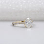 Diamond ring with gold band on a light gray background

