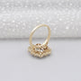 Gold ring with a diamond on a light gray background