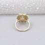 Gold ring with diamond on a light gray background