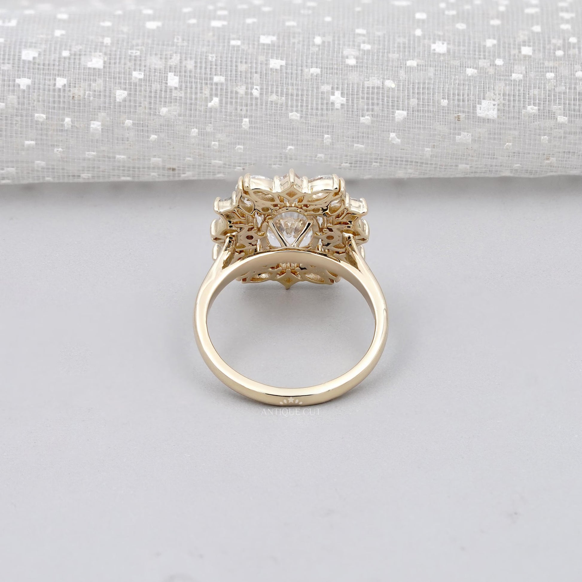 Gold ring with diamond on a light gray background