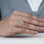 Close-up of a hand wearing a rose gold diamond ring on a Nautral background

