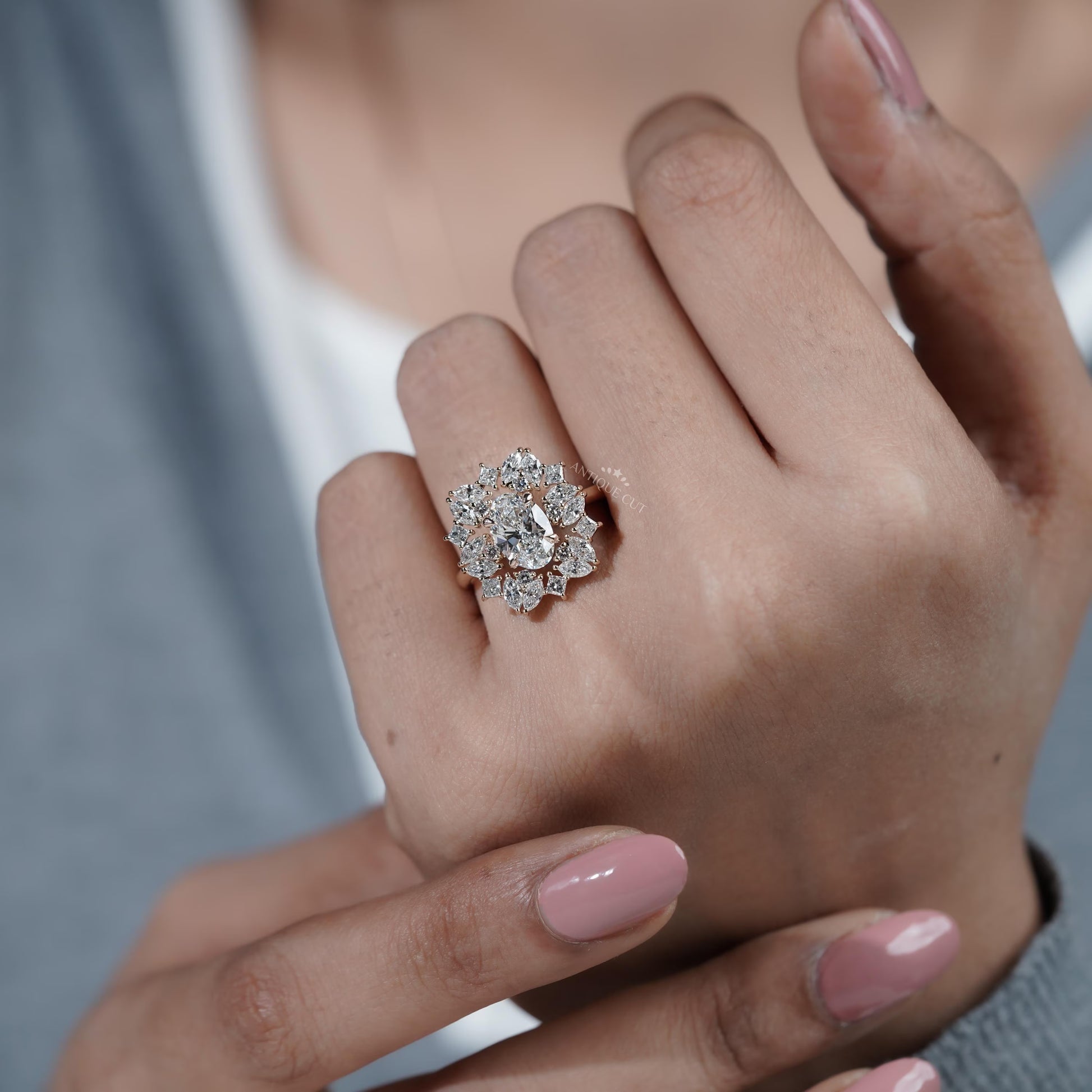 Close-up of a hand wearing a diamond ring with a blurred background