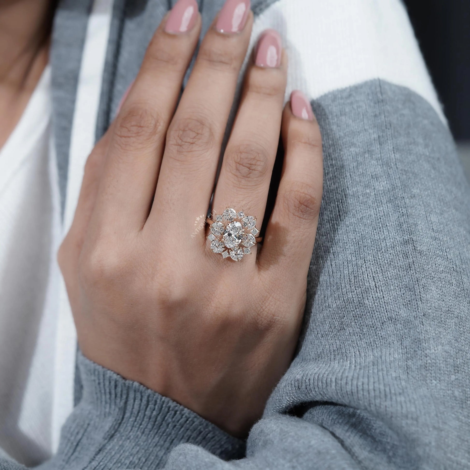 Hand wearing a diamond ring with a blurred background
