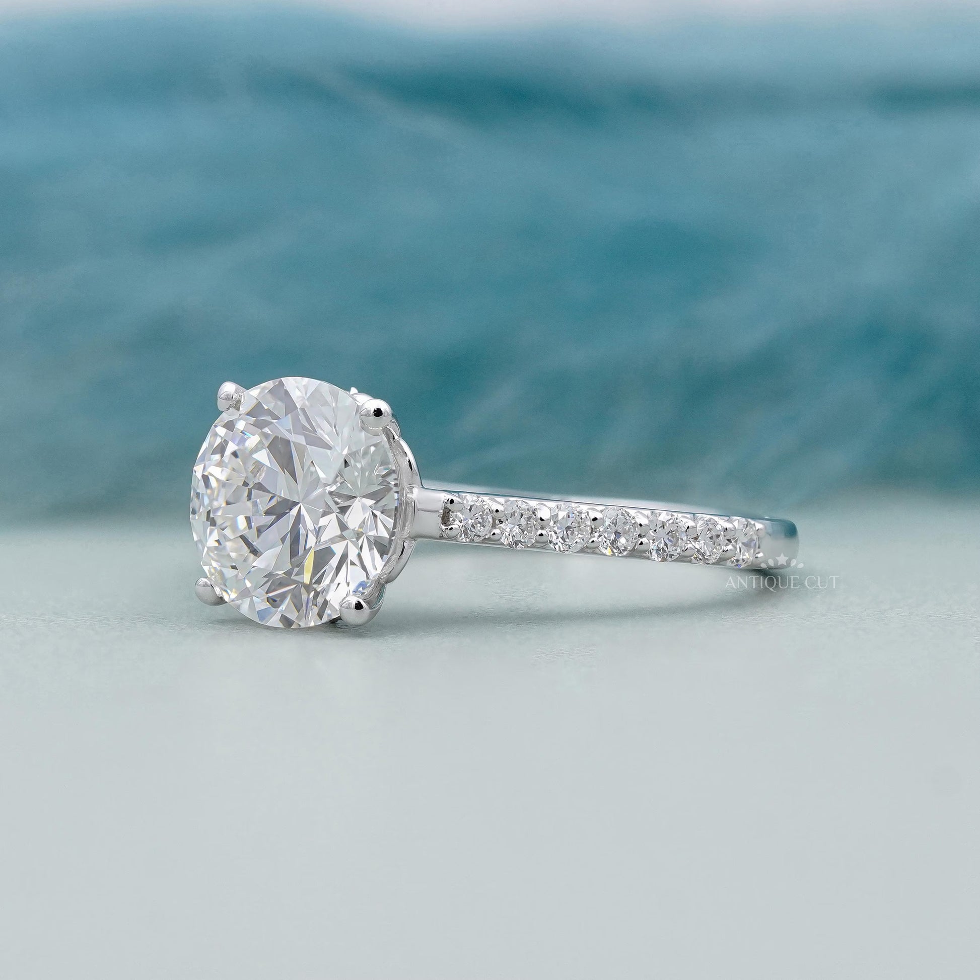 White gold round cut diamond ring with side stones
