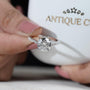Round cut diamond ring with side stones
