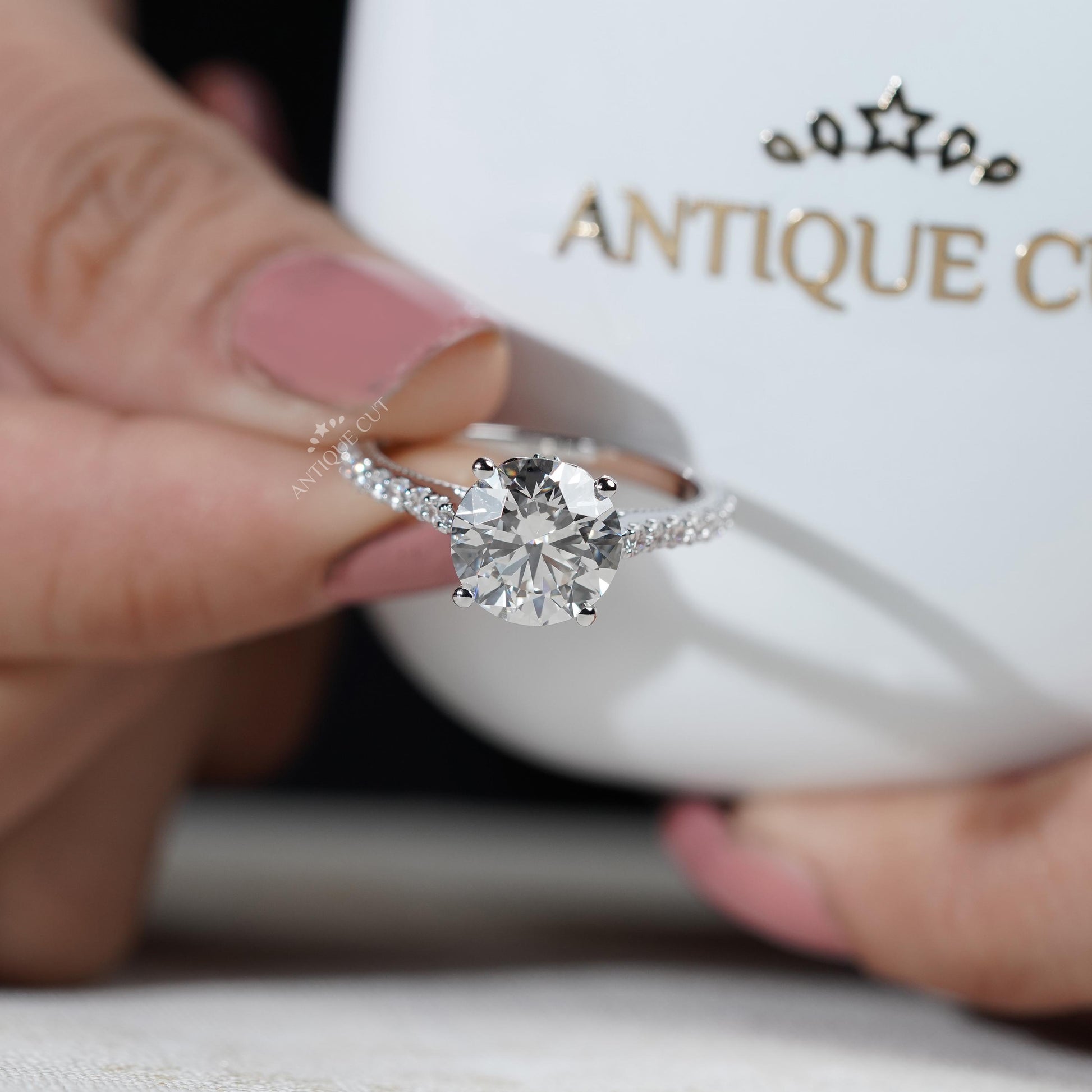 Round cut diamond ring with side stones
