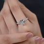 Close-up of a hand wearing a diamond ring with a blurred background