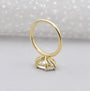Gold ring with a diamond on a gray background

