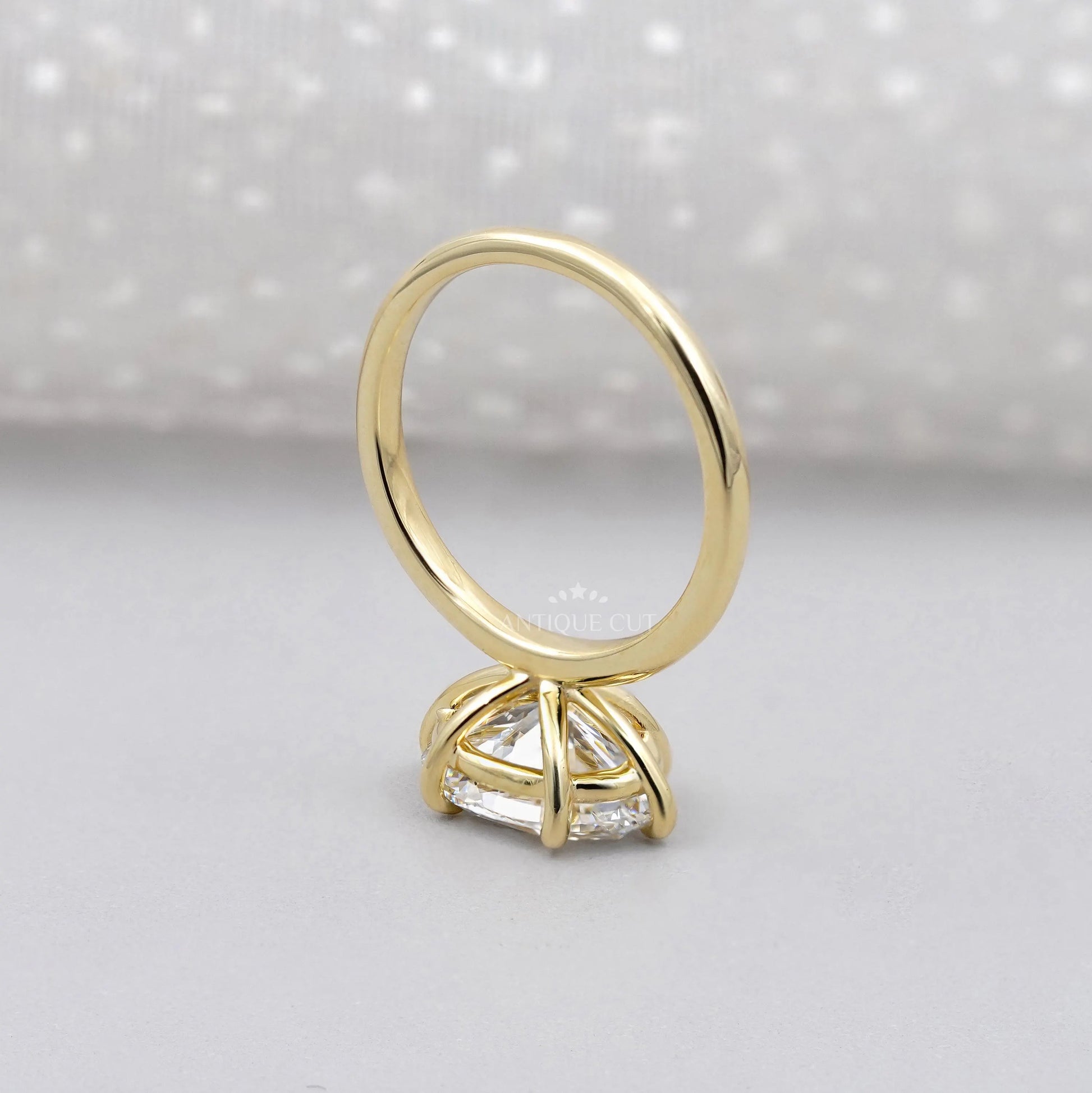 Gold ring with a diamond on a gray background

