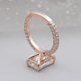 Rose gold ring with diamond accents on a light gray background

